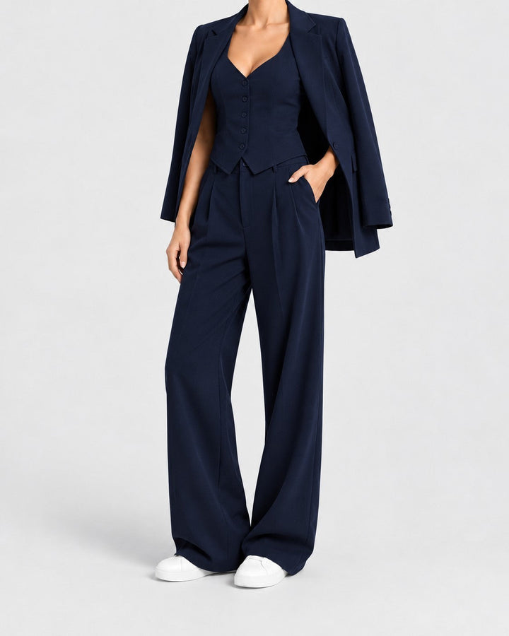 Luna Moda navy blue 3-piece suit featuring a tailored vest, wide-leg trousers, and a blazer draped over the shoulders.