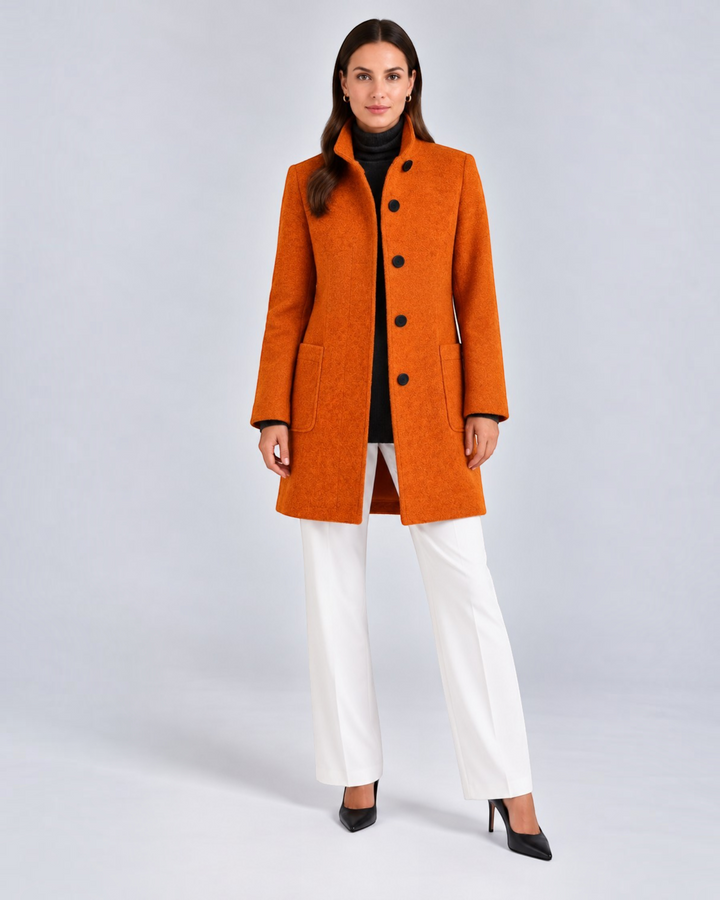 Luna Moda NELLA burnt orange high neck wool-blend coat worn by a model with white trousers and black heels