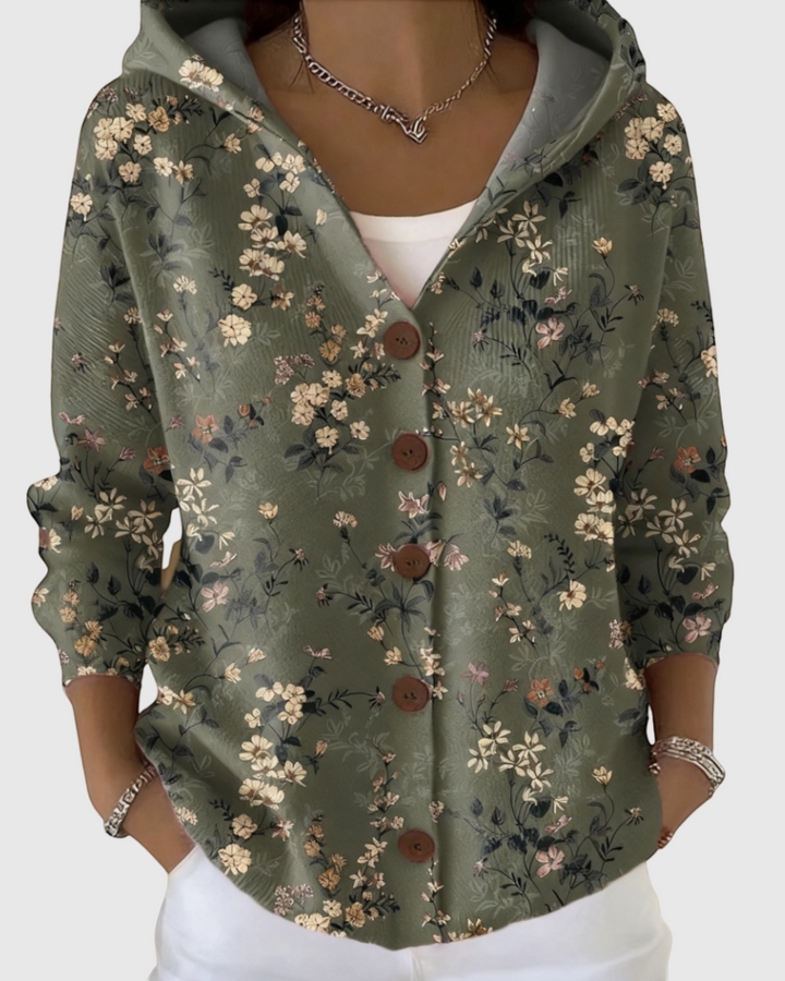 Luna Moda floral print cardigan in sage green with a hood, button-down front, and long sleeves worn over a white top.