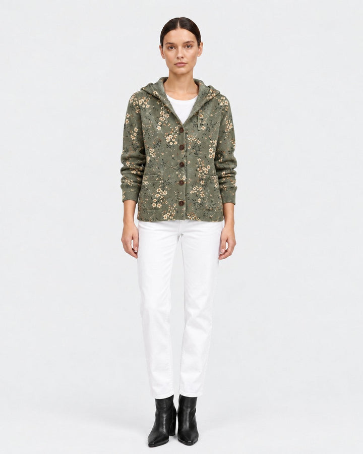 Luna Moda floral knit cardigan with hood in olive green worn by a model with white trousers and black boots