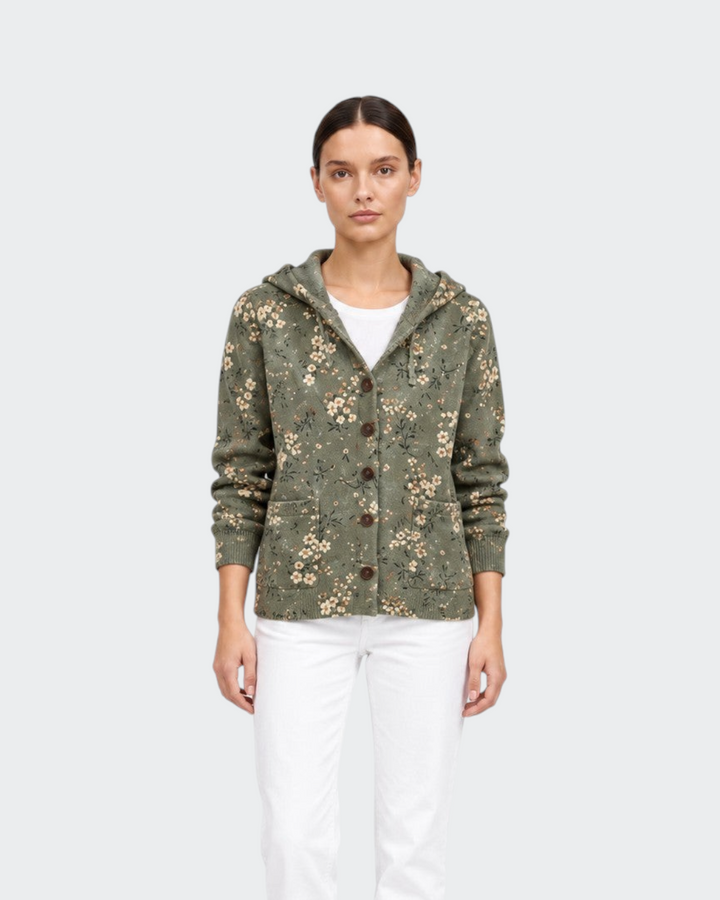 Luna Moda floral knit cardigan with hood in olive green worn by a model with white trousers and black boots