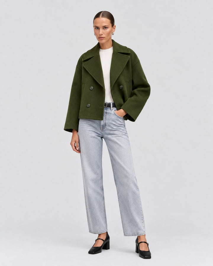 Luna Moda Costanza olive green double-breasted cropped jacket worn by a model with light wash jeans and heels.