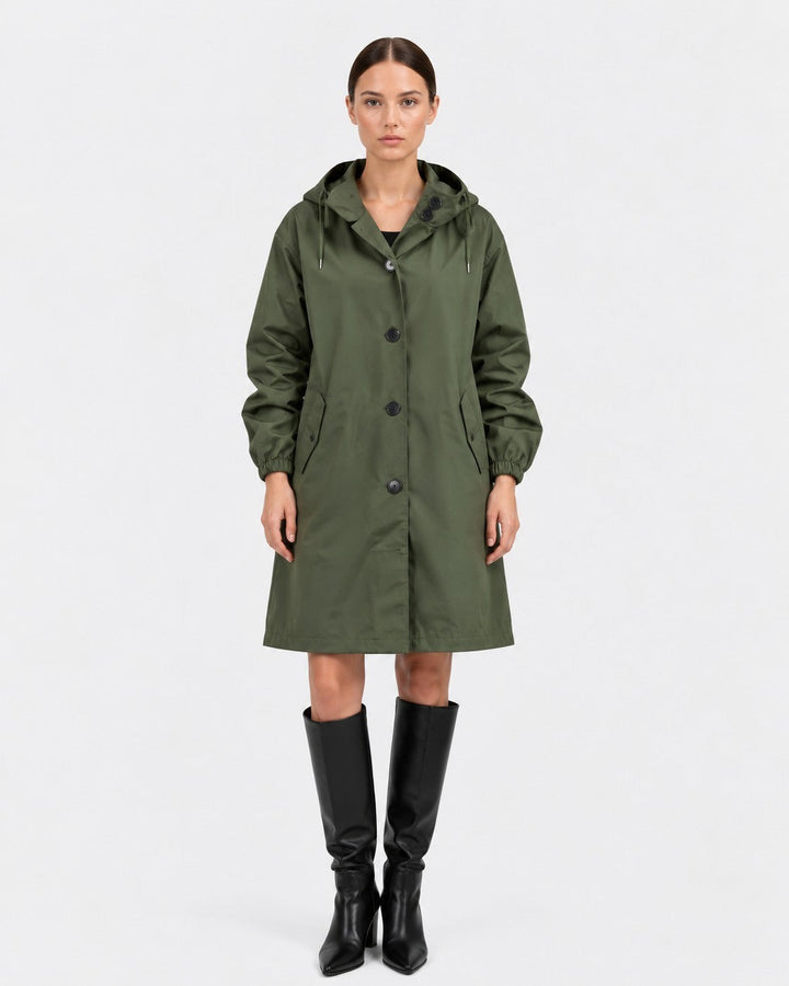 Luna Moda olive green oversized waterproof raincoat with hood and pockets worn by a model with black knee-high boots