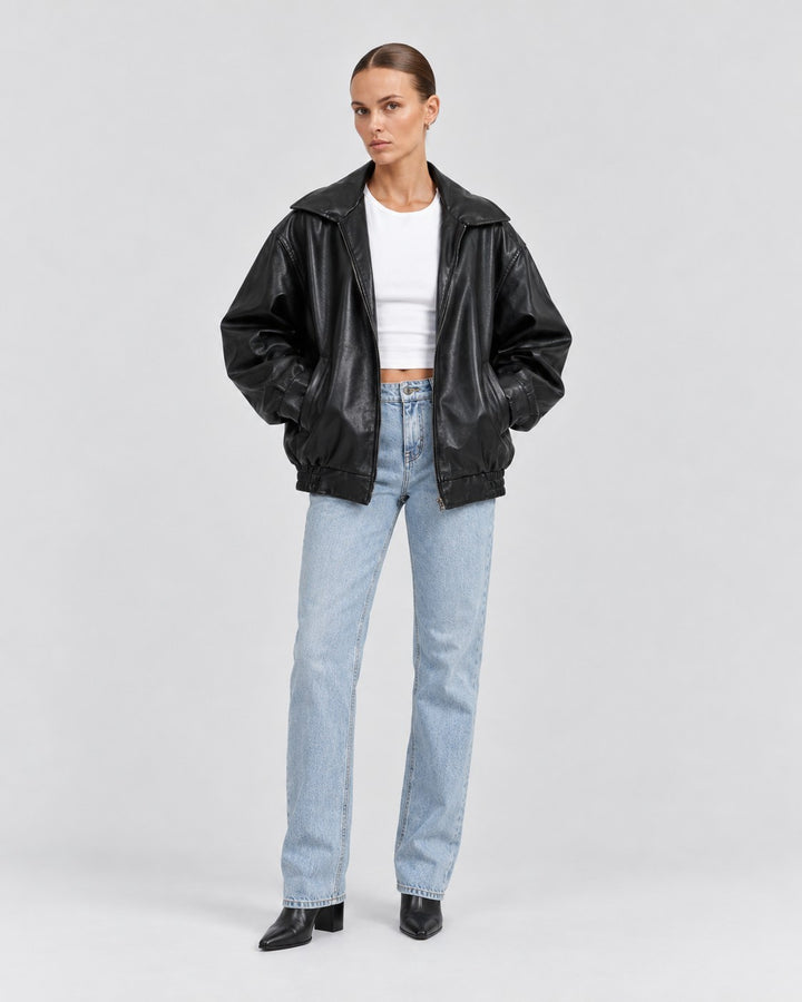 Luna Moda black oversized PU leather jacket worn by a model with a white crop top and light wash jeans