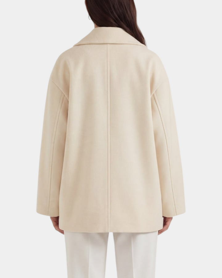 Luna Moda Corinna oversized cream coat with a relaxed fit and clean lines, shown from the back on a model.