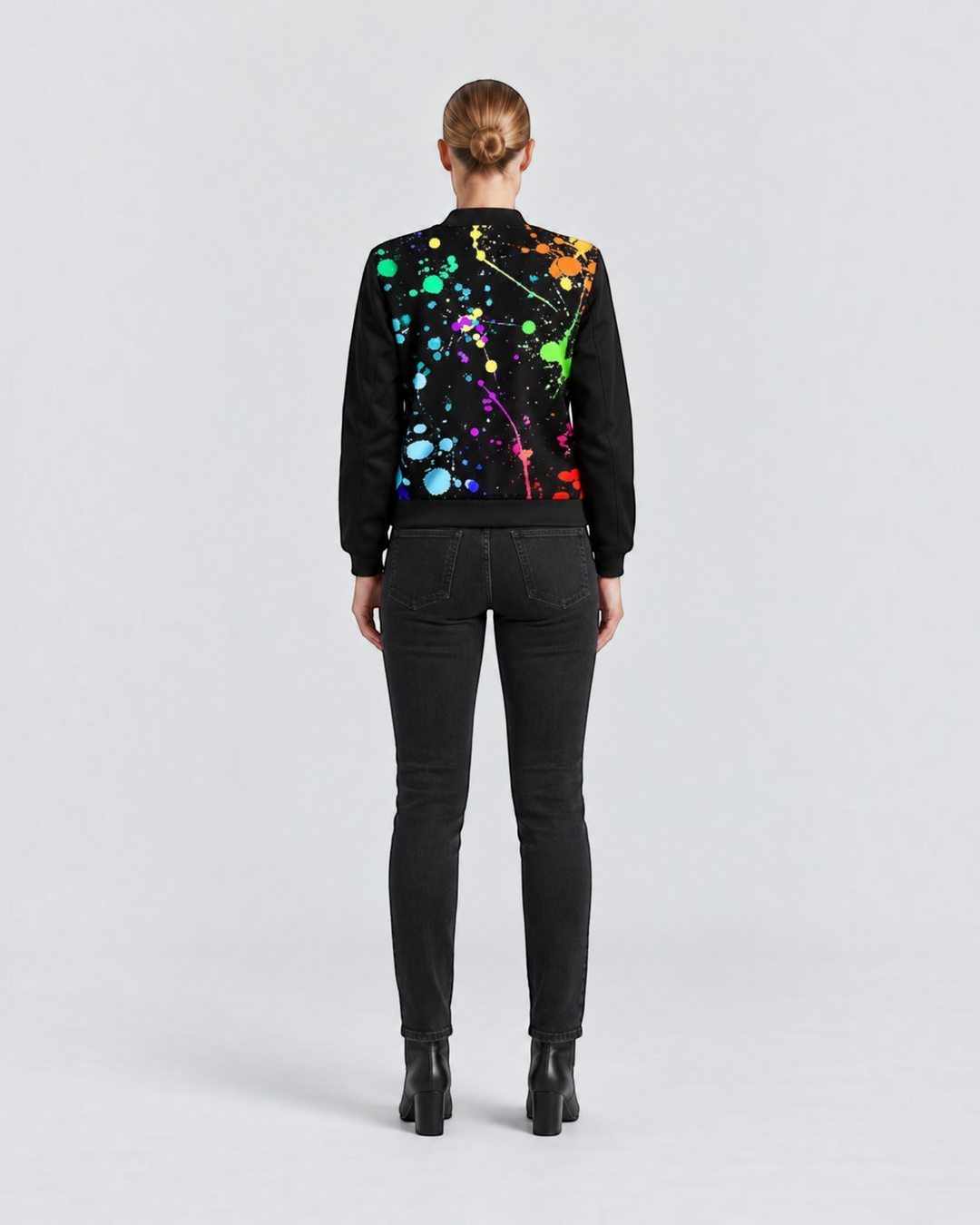 Luna Moda jacket with a vibrant multi-colored paint splatter print on the back, worn with black jeans and boots.
