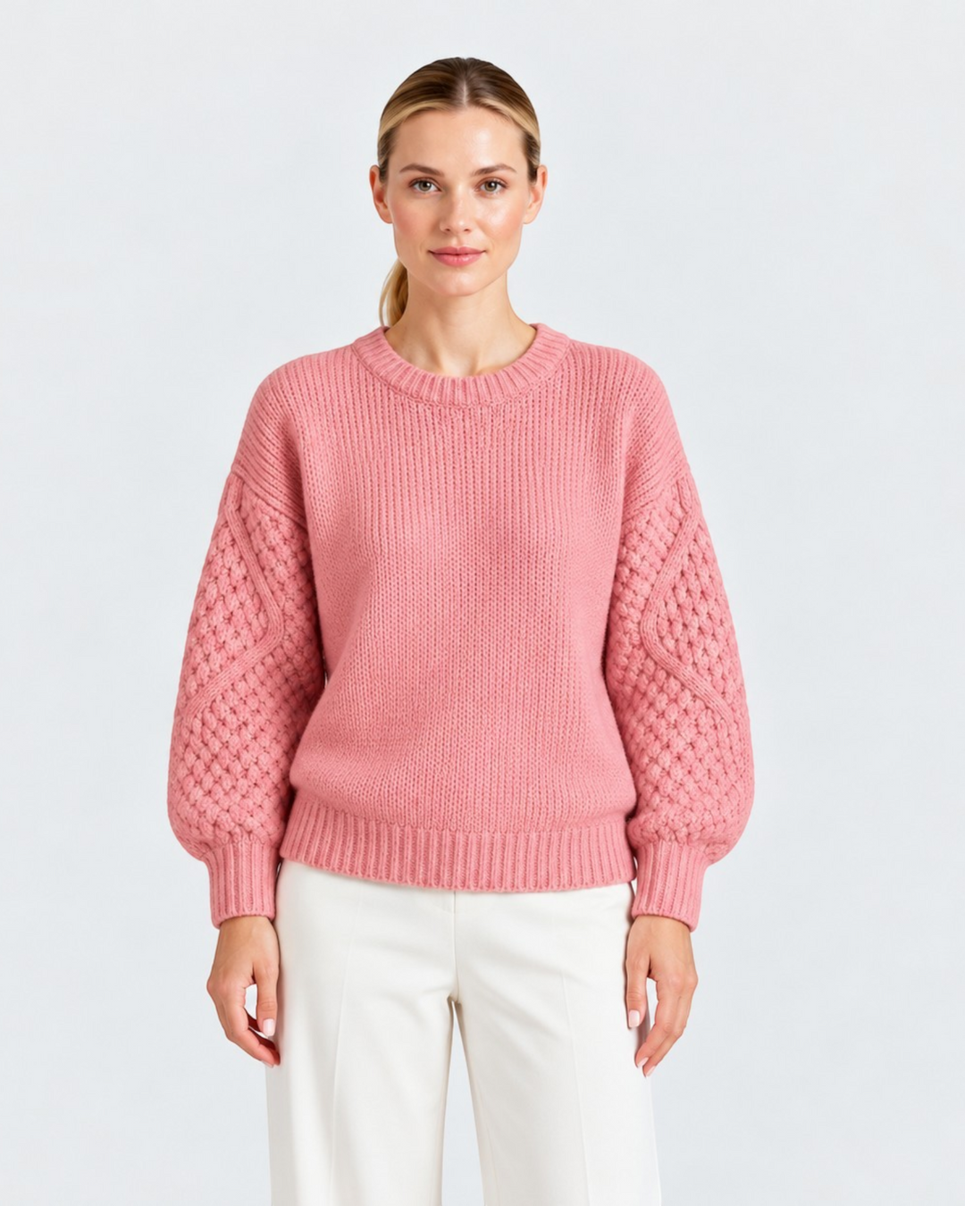 Luna Moda pink sweater with a ribbed body and textured cable knit sleeves worn by a model.