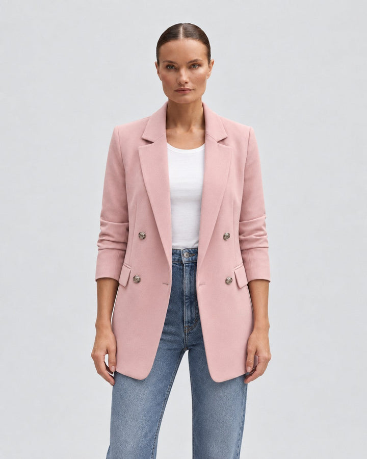 Luna Moda pink double-breasted blazer for women with notched lapels and silver buttons worn over a white top