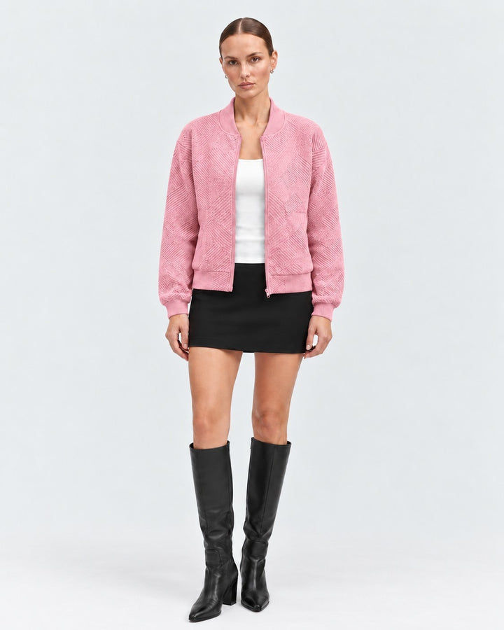 Luna Moda pink bomber jacket with a geometric pattern, ribbed cuffs, and front zip, worn by a model.