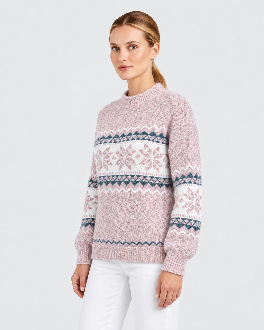 Luna Moda model wearing a soft pink knit sweater with a white and teal Nordic snowflake pattern and ribbed crew neck.