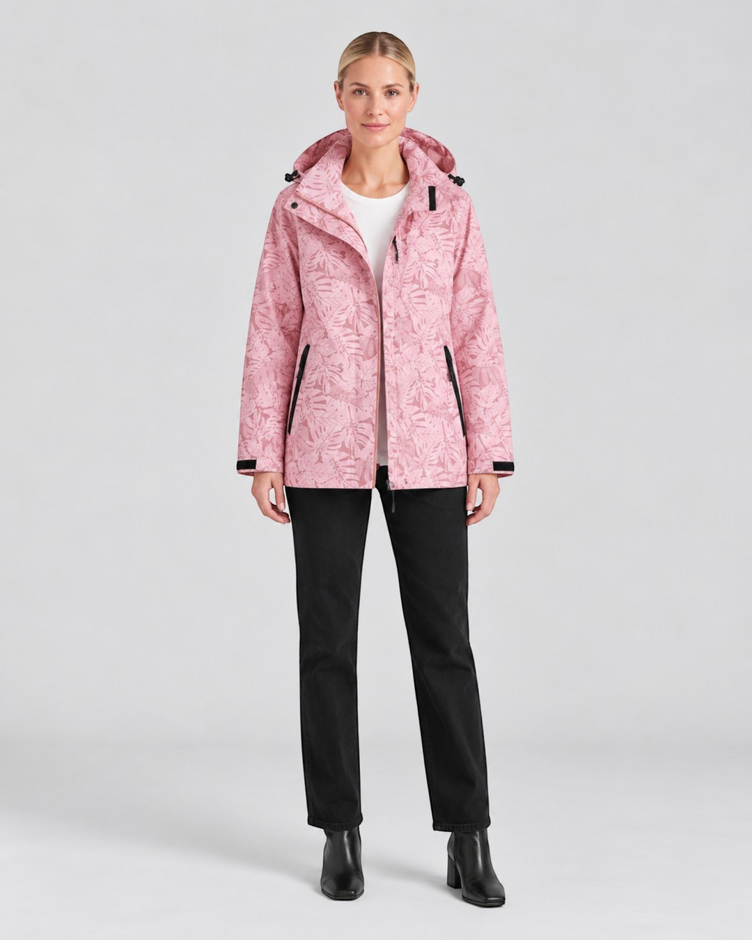 Luna Moda light pink waterproof hooded jacket with leaf print worn by a model with black trousers
