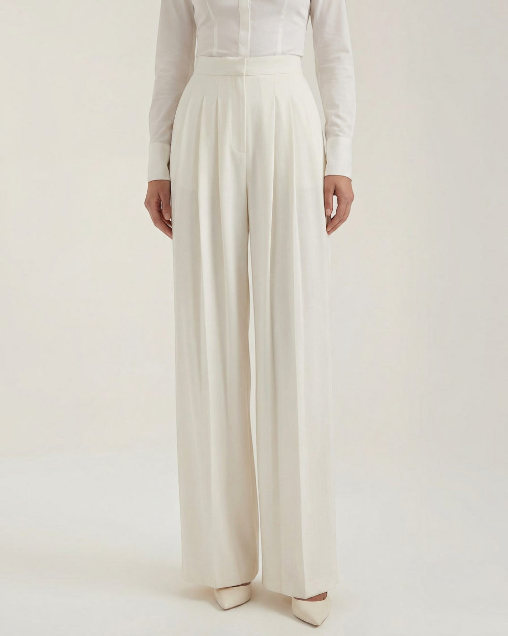 Luna Moda ivory crepe palazzo trousers with meticulous pleats and a high-waisted tailored fit on a model