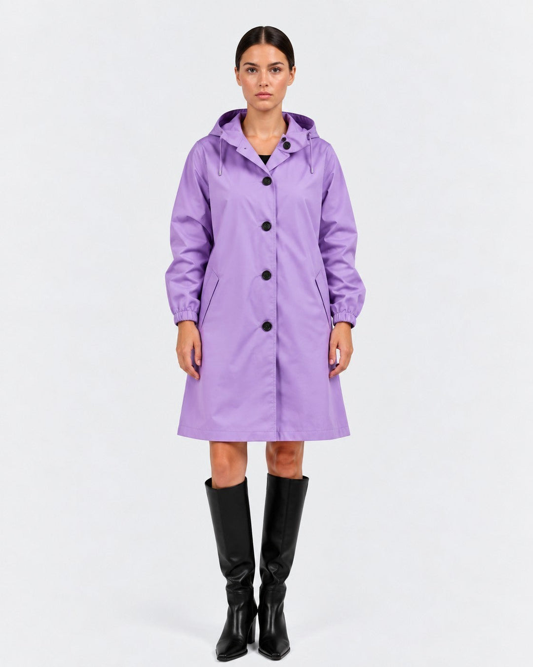 Luna Moda oversized purple waterproof raincoat with hood and pockets worn by a model with black knee-high boots.
