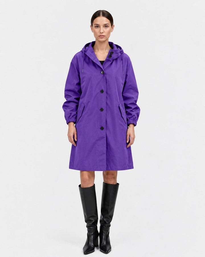 Luna Moda purple oversized waterproof raincoat with hood, button front, and pockets worn by a model