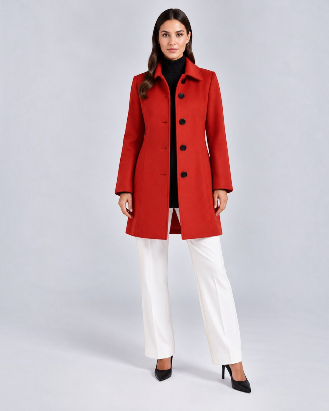 Luna Moda red fit and flare coat with a classic collar and button closure worn by a woman with white trousers