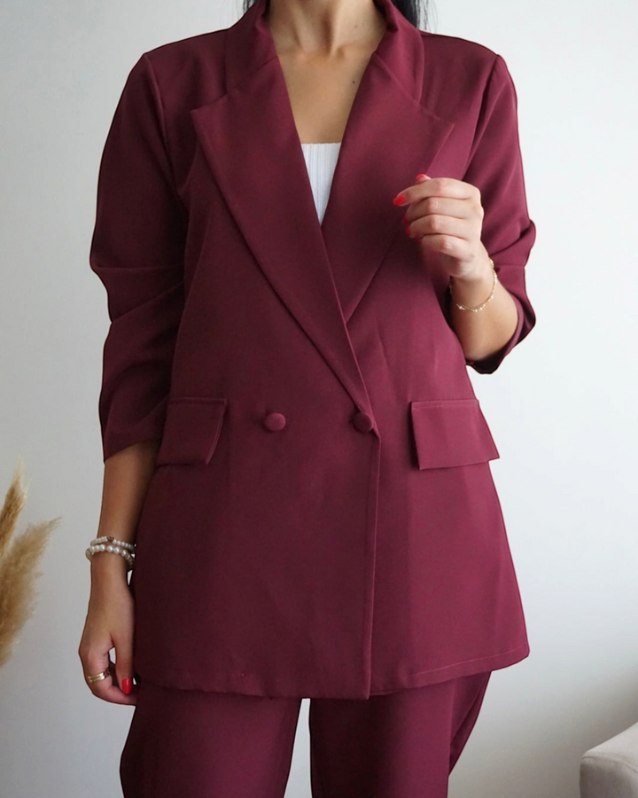 Luna Moda wine-colored oversized blazer and fluid trousers set with button details worn by a woman