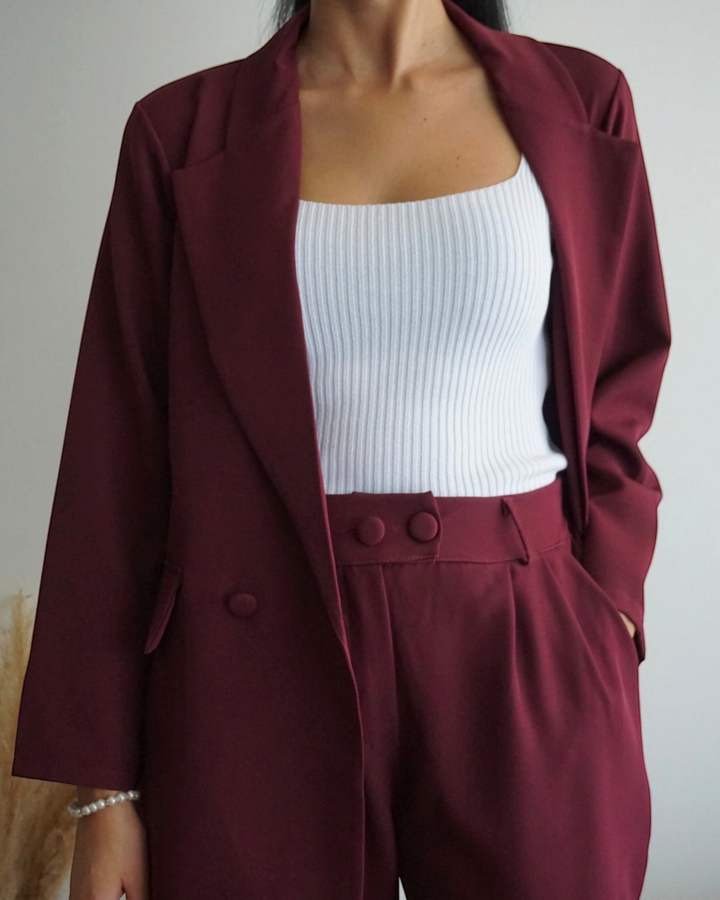 Luna Moda wine-colored oversized blazer and fluid trousers set with button details worn over a white ribbed top