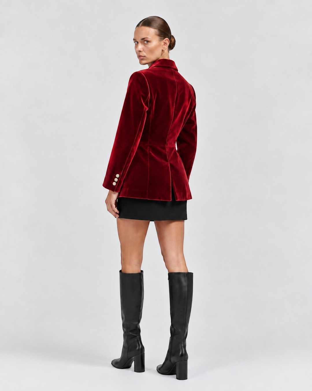 Luna Moda tailored red velvet blazer worn by a model with a black skirt and knee-high boots, back view