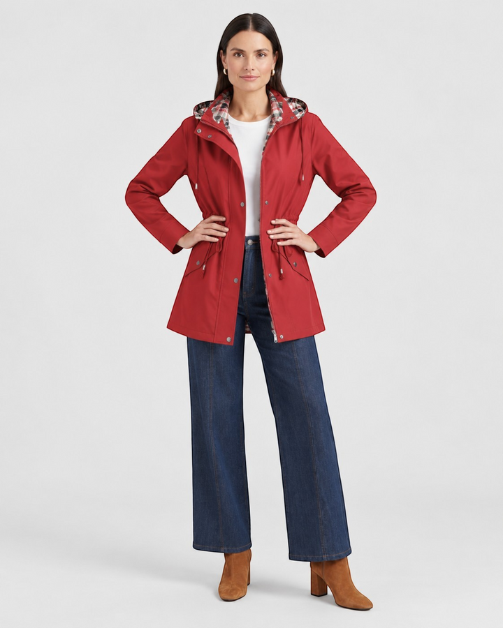 Luna Moda red waterproof hooded jacket with adjustable waist and plaid lining worn by a woman with blue jeans