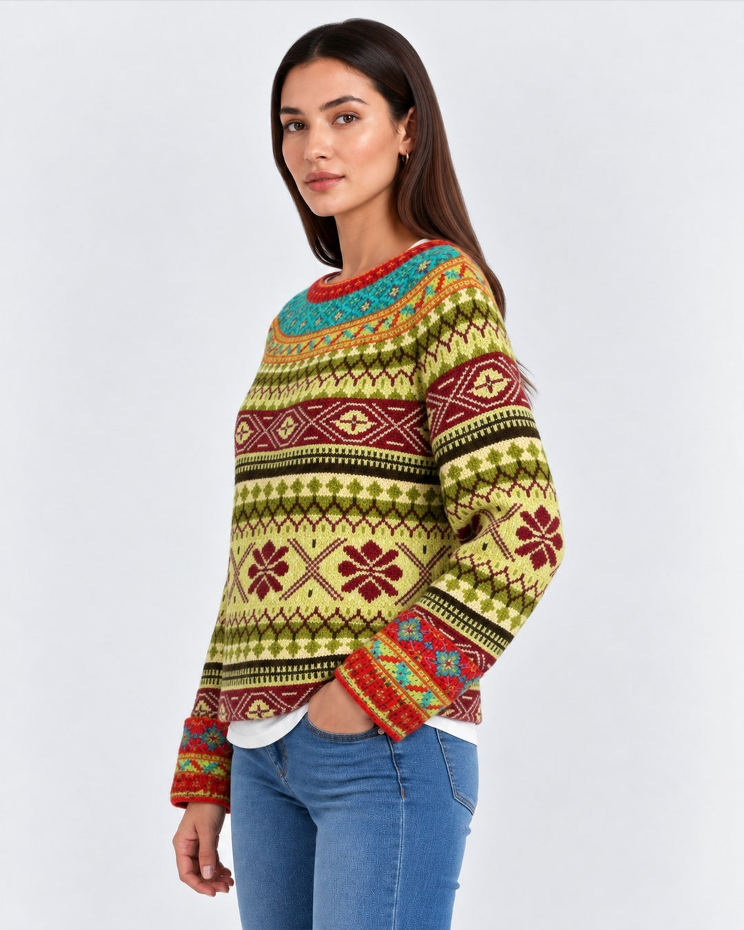 Luna Moda handmade sweater featuring a colorful retro Nordic pattern in green, red, and teal on a woman.