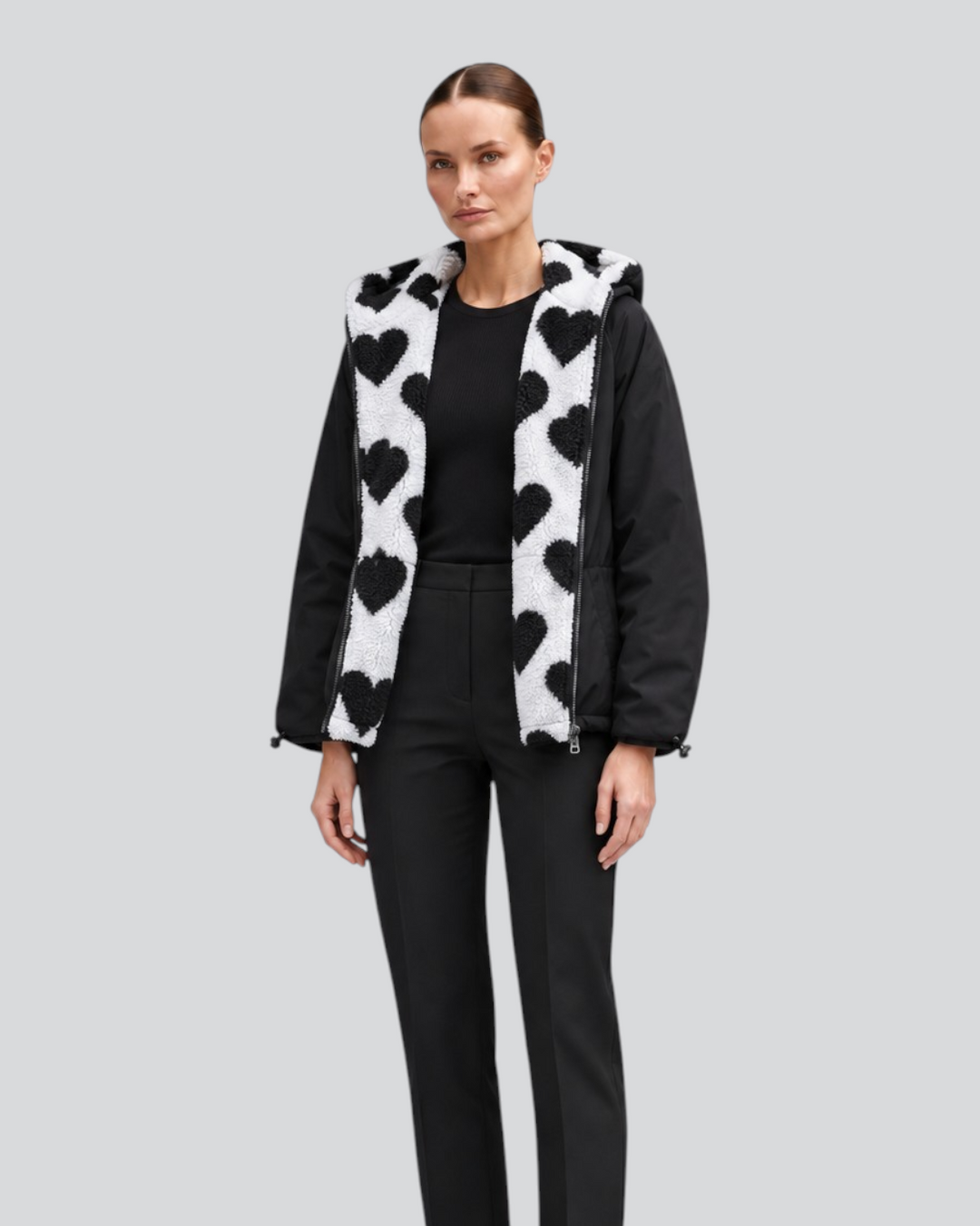 Luna Moda reversible cropped jacket featuring a black side and a white faux-fur side with black heart patterns
