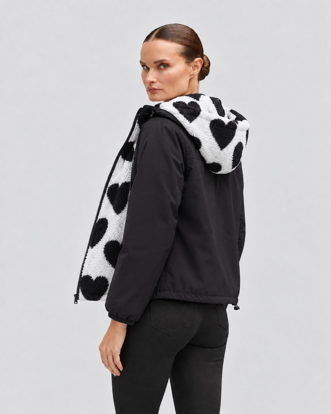 Luna Moda reversible cropped jacket in black with white and black heart-patterned faux shearling lining and hood