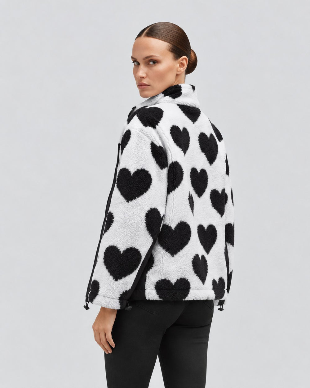 Luna Moda reversible short jacket in white with black heart pattern, worn by a model from the back view.