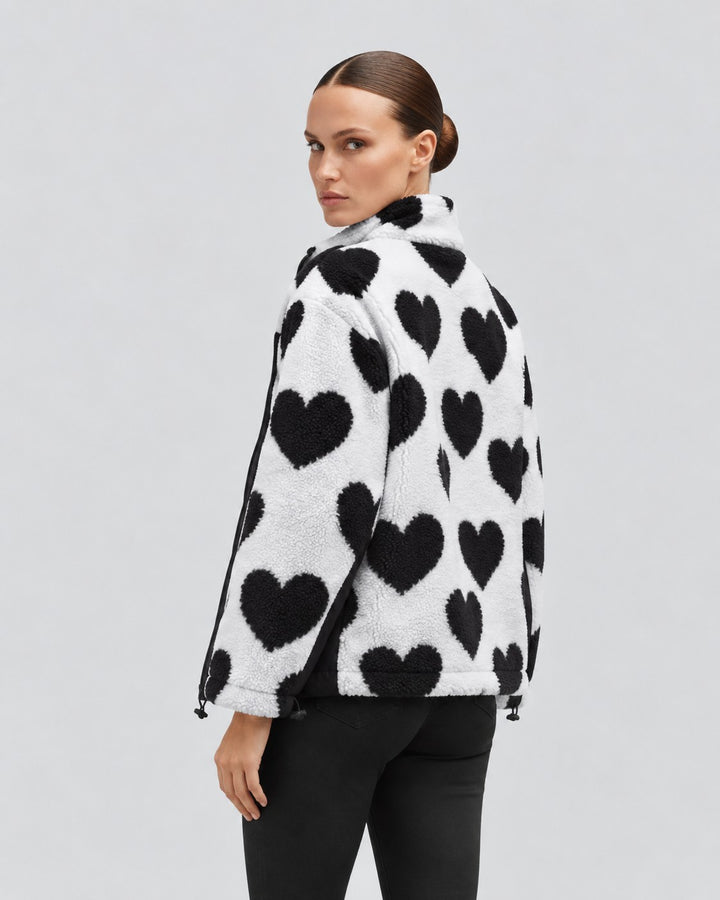Luna Moda reversible short jacket in white with black heart pattern, worn by a model from the back view.