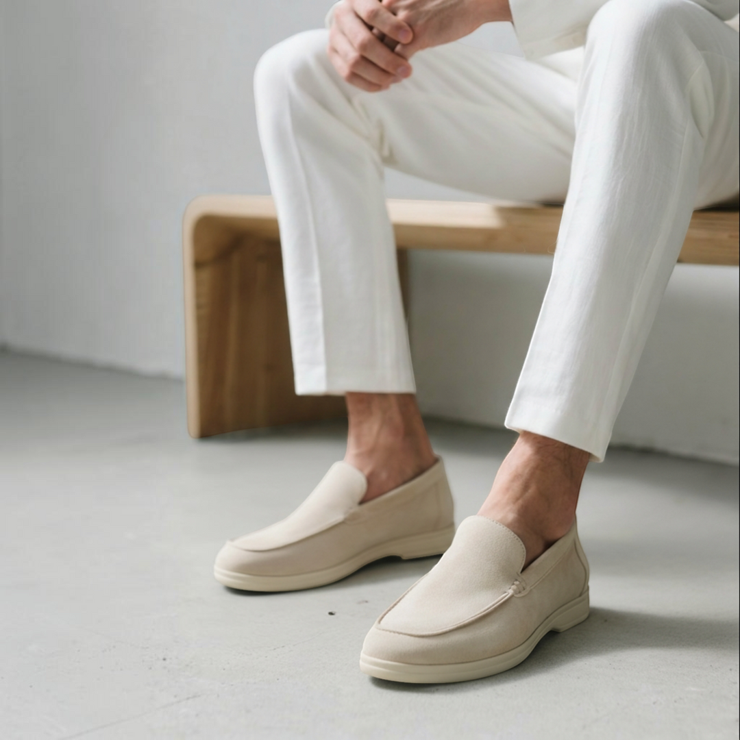 Luna Moda ROMEO beige suede loafers with supportive insoles worn by a man in white trousers on a wooden bench