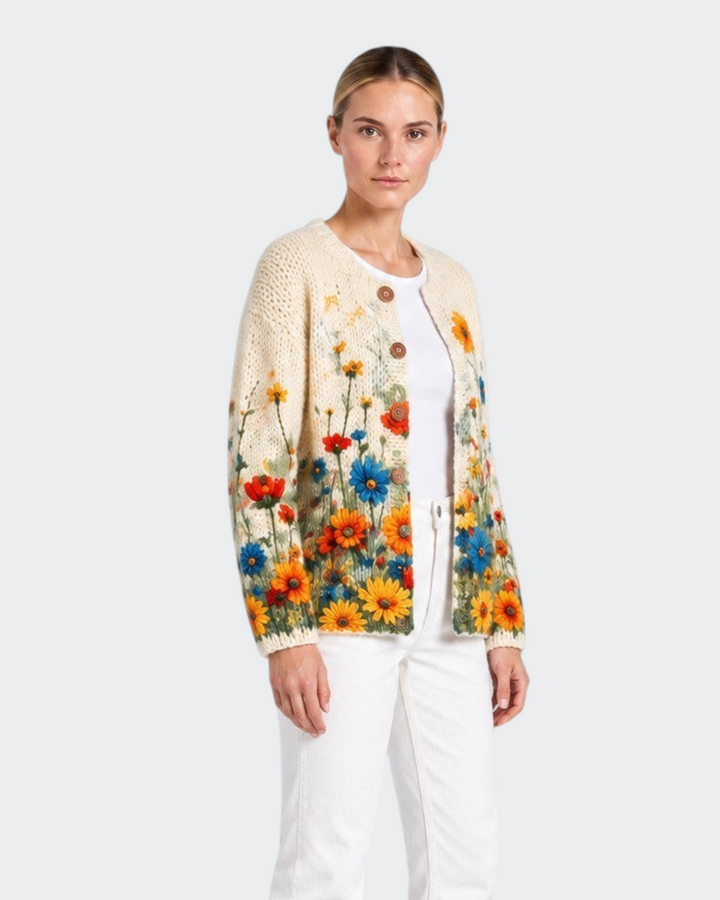 Luna Moda Rosalia cream knit cardigan featuring a vibrant vintage wildflower print, worn with white jeans.
