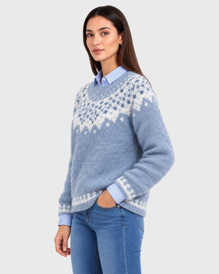 Luna Moda Rossella blue Fair Isle sweater with white jacquard yoke pattern worn by a model over a striped shirt.