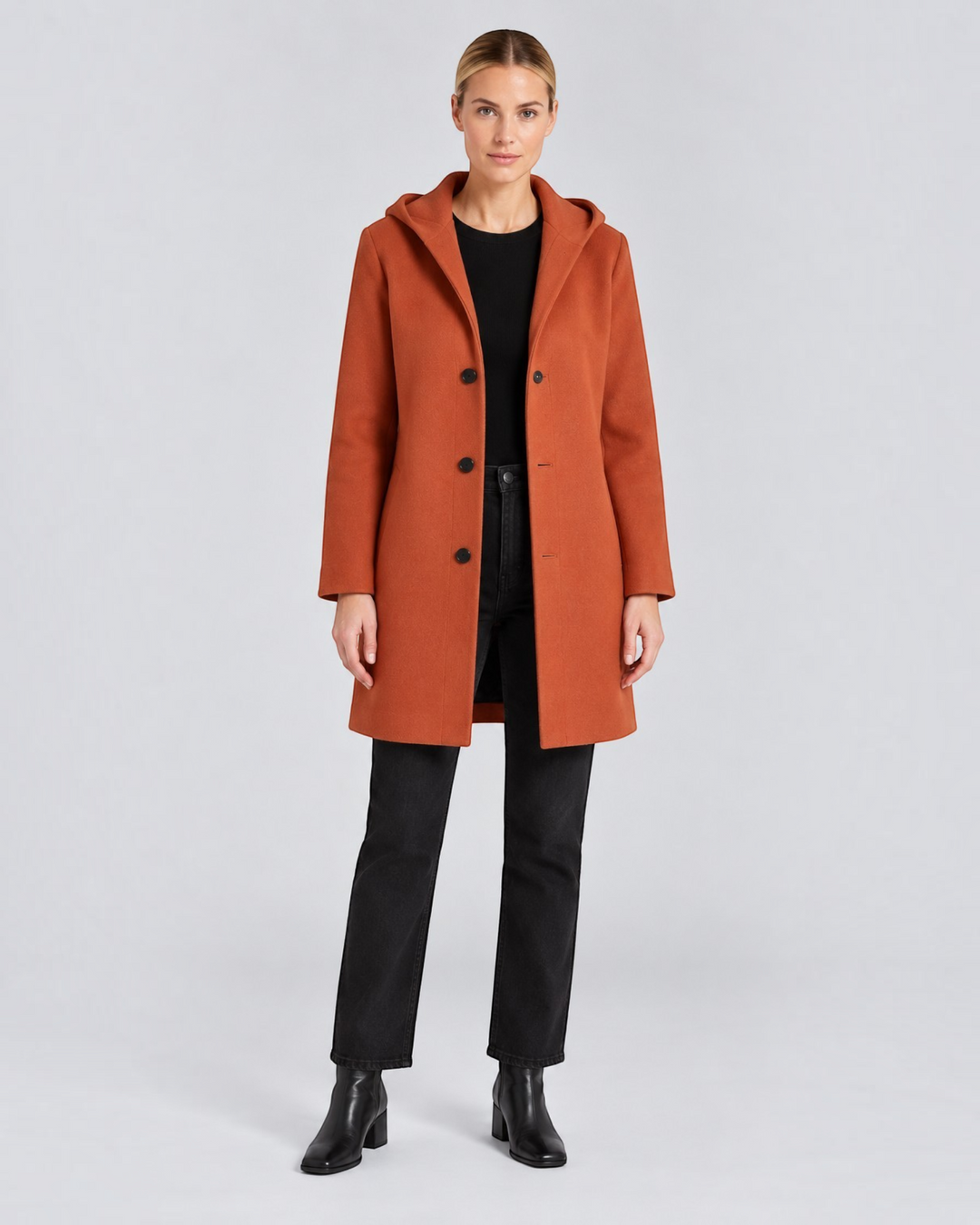Luna Moda Annetta short rust-coloured hooded coat with button closure worn by a model with black jeans and boots