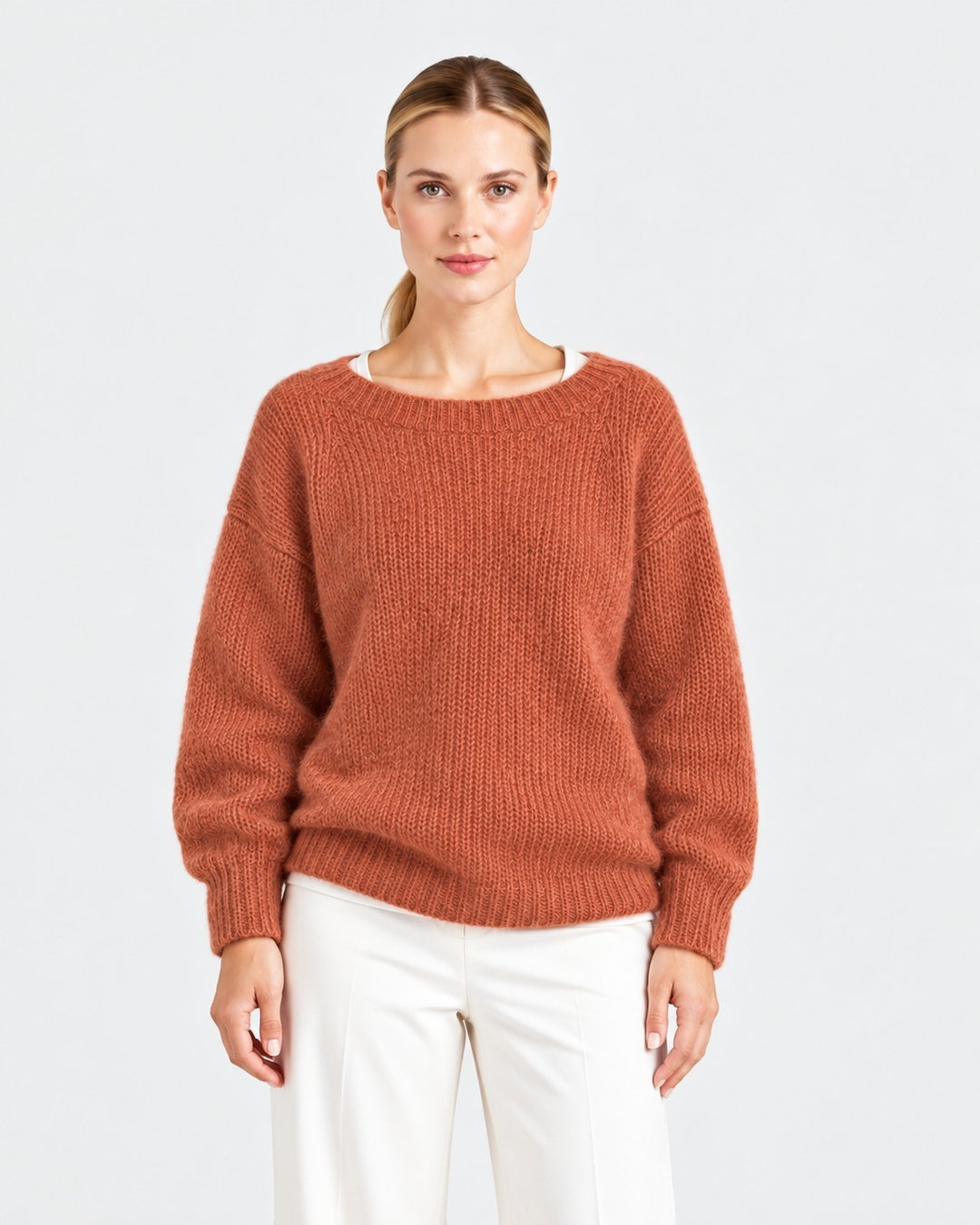 Luna Moda Elda rust orange crew neck sweater with a soft, relaxed fit worn by a model against a white background.