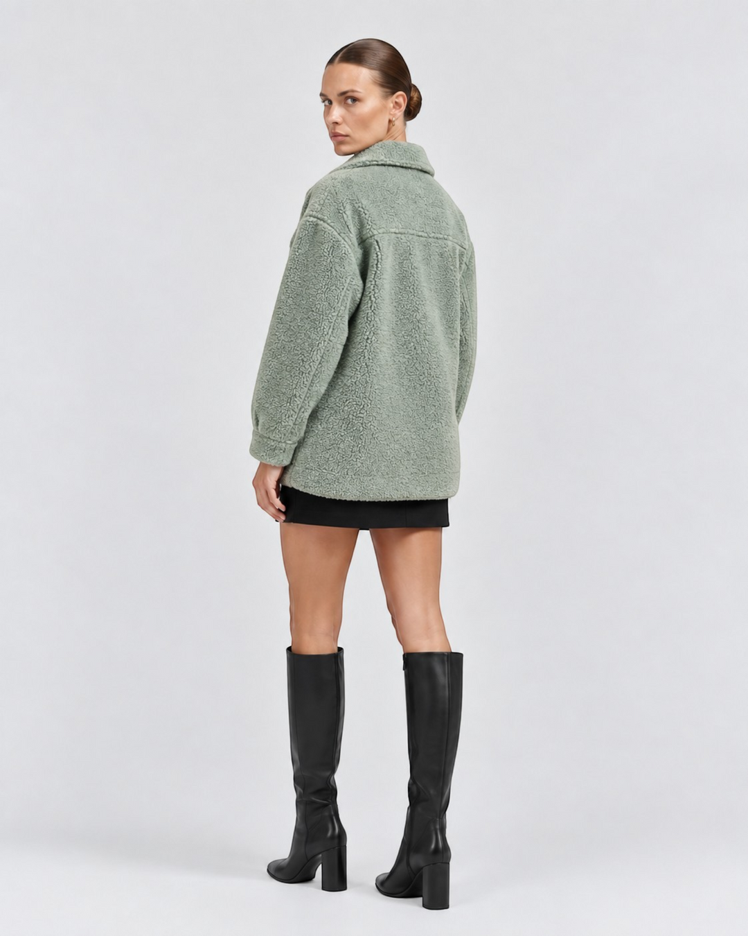 Luna Moda sage green teddy fleece jacket with collar, worn by a model with black skirt and high boots, back view