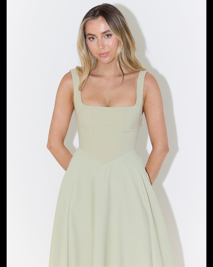 Luna Moda Scarlett Grace sage green dress with a square neckline and fitted bodice on a model