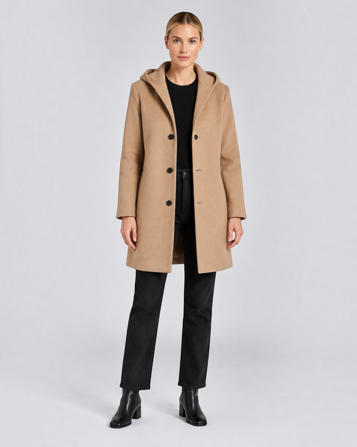 Luna Moda Annetta short camel coat with hood and button closure worn by a model with black jeans and boots