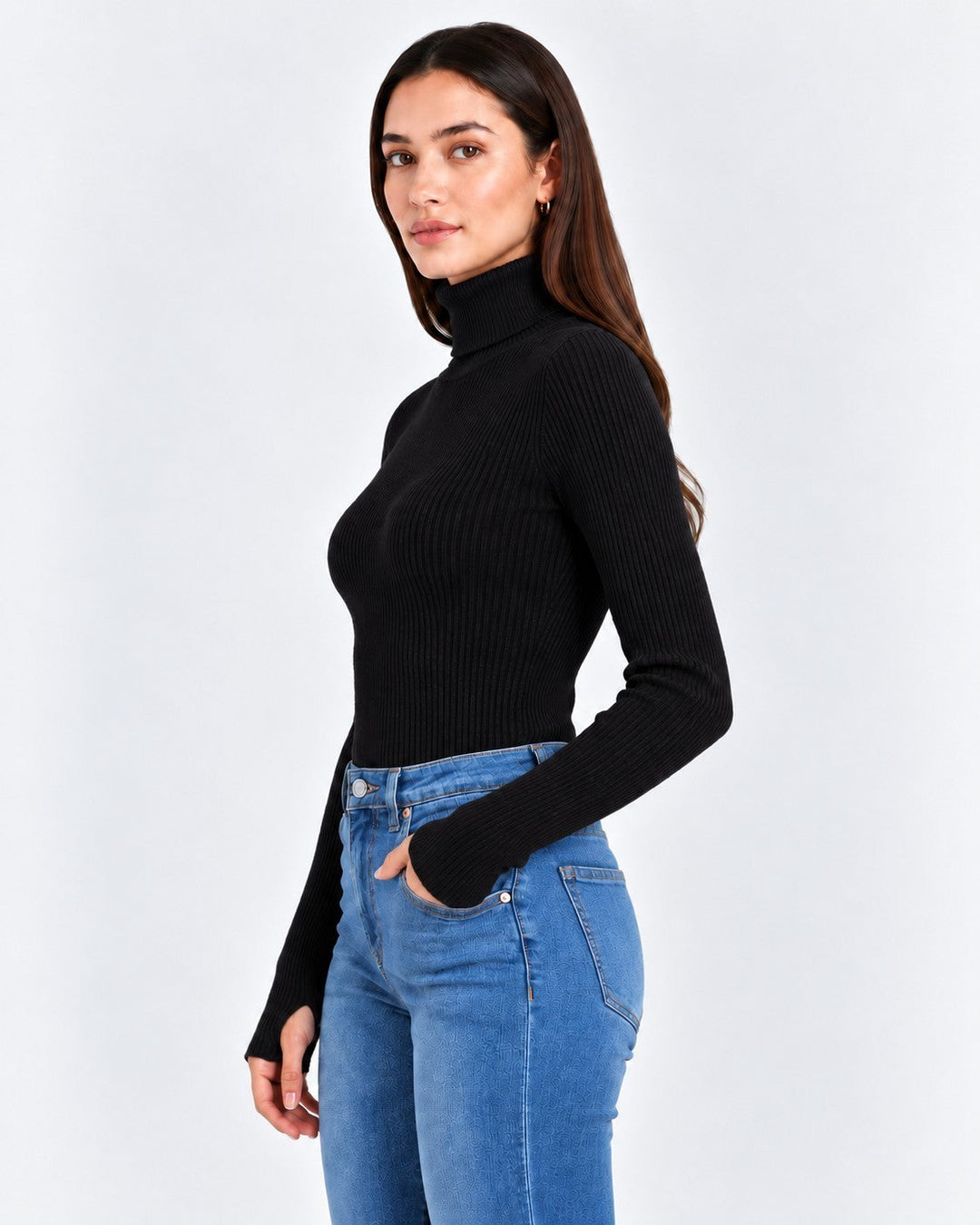 Luna Moda Stefania black ribbed turtleneck sweater worn by a woman with blue jeans, side profile view.