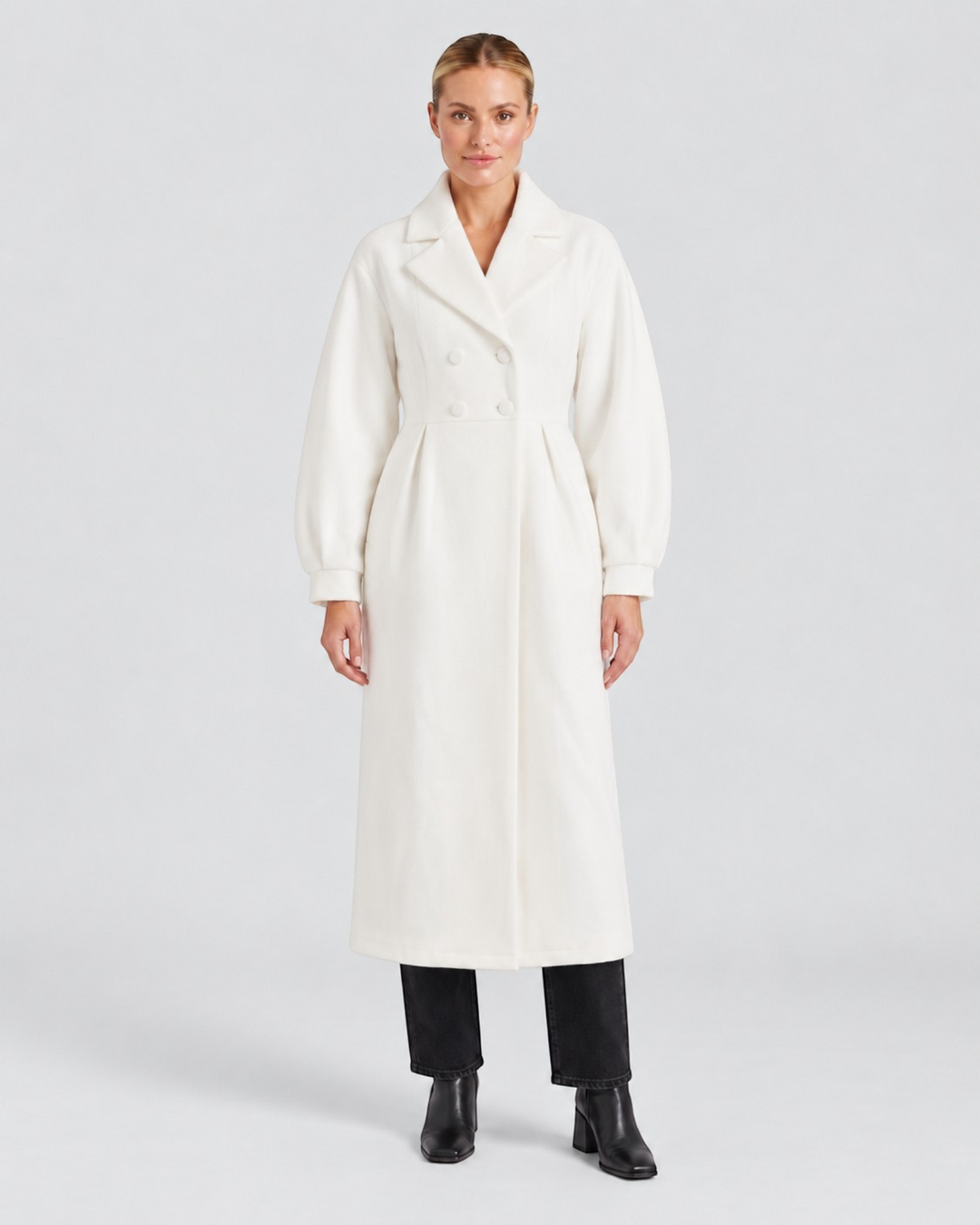 Luna Moda Stephanie white trench coat with a defined waist and puff sleeves worn by a model on a light background