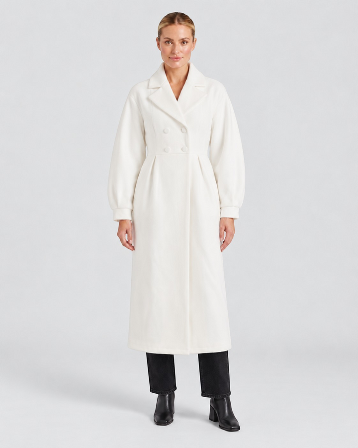 Luna Moda Stephanie white trench coat with a defined waist and puff sleeves worn by a model on a light background