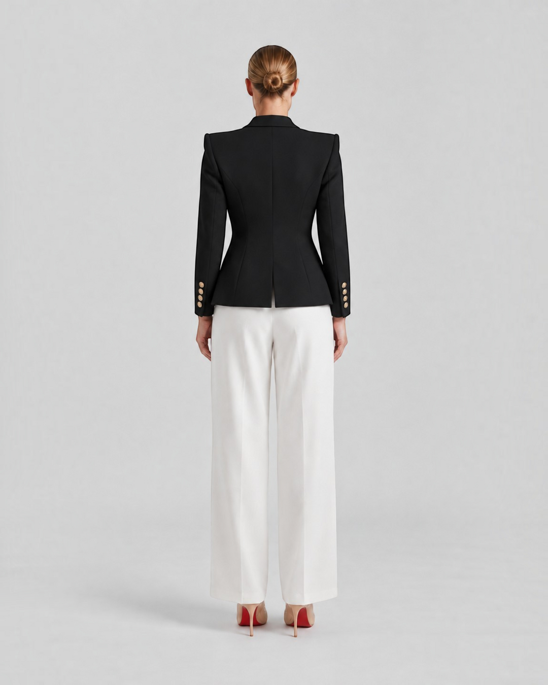 Luna Moda Paolina structured black blazer with gold decorative buttons worn with white trousers, back view