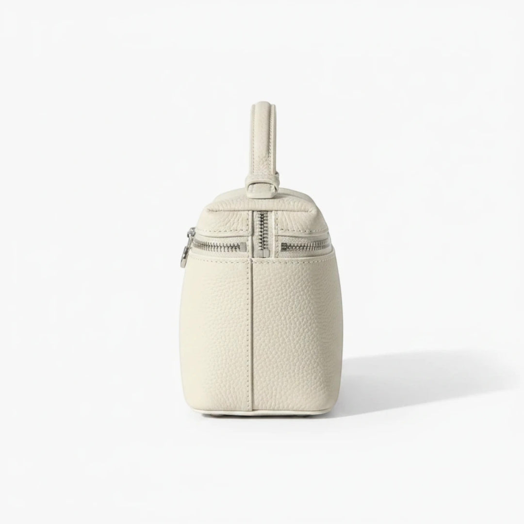 Luna Moda structured cream leather handbag with silver metal zipper details and top handle, side view