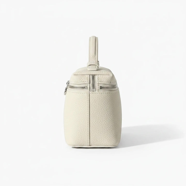 Luna Moda structured cream leather handbag with silver metal zipper details and top handle, side view