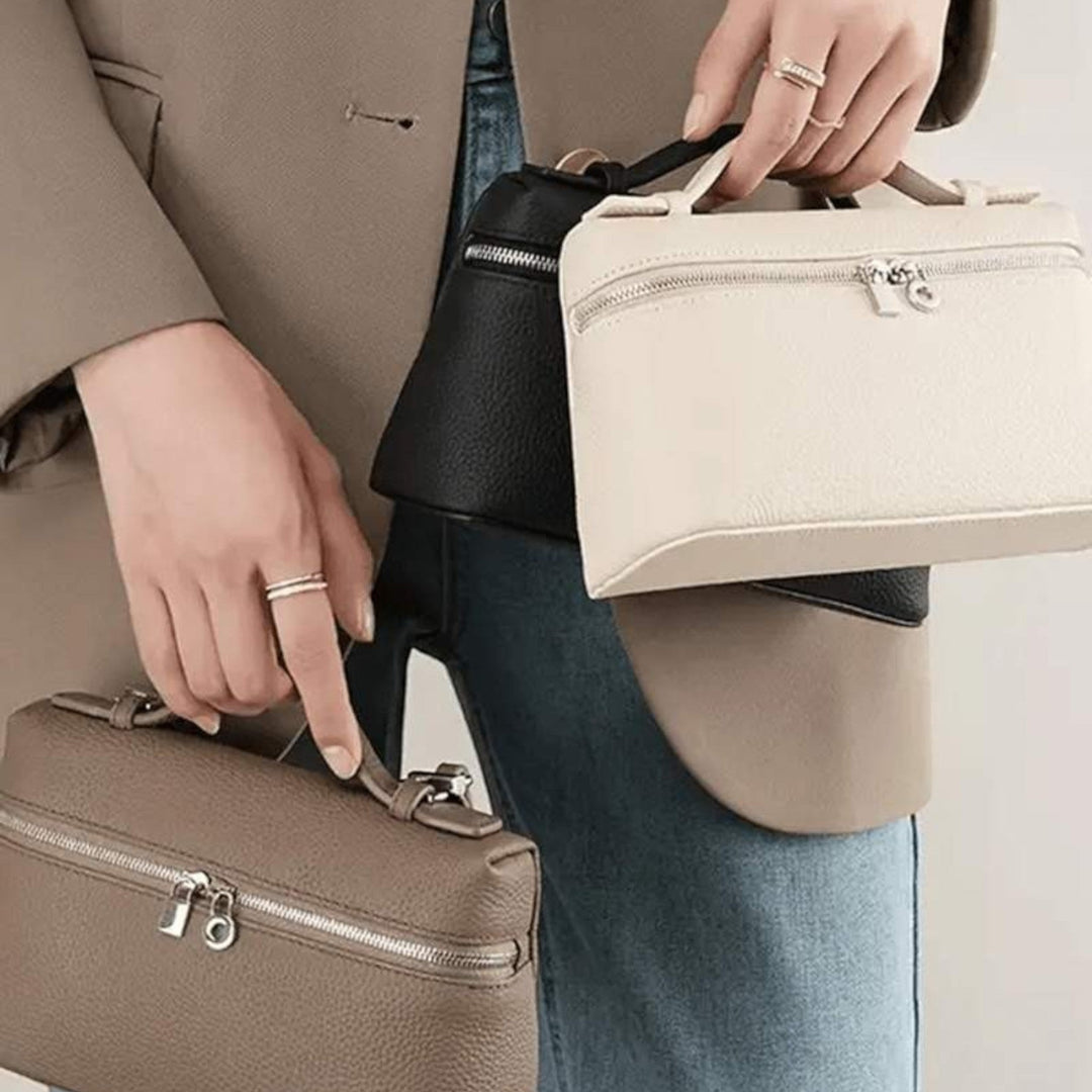 Luna Moda structured handbags in beige, black, and taupe with silver hardware, held by a woman in a blazer.