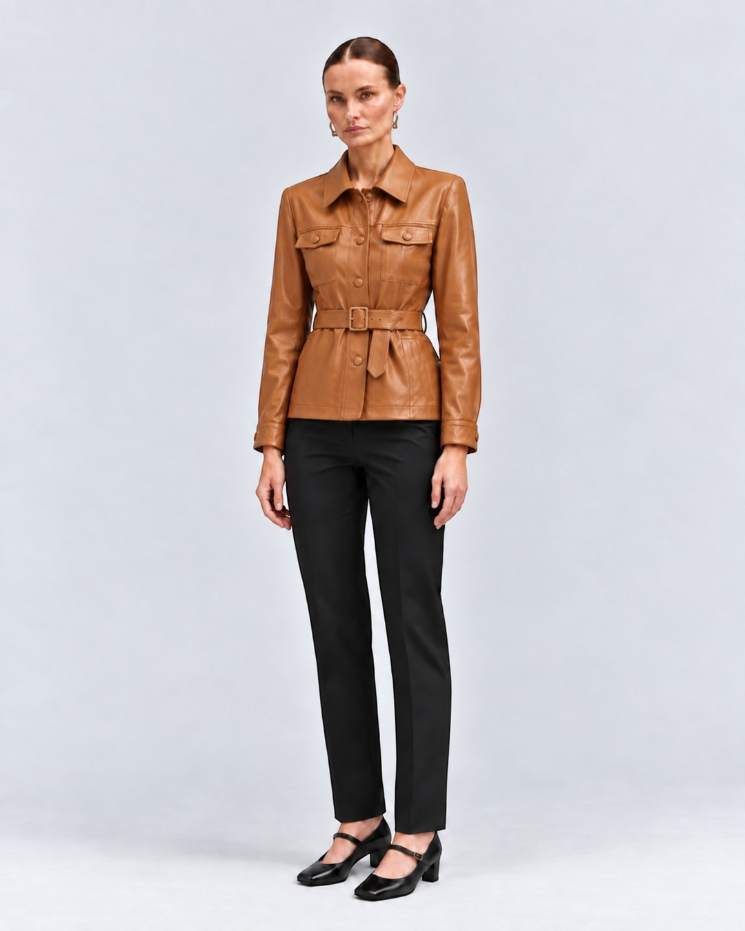 Luna Moda tan faux leather jacket with adjustable belt, large pockets, and structured collar worn by a model