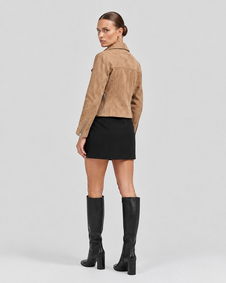 Luna Moda tan suede biker jacket with silver zippers and wide collar, worn by a model with a black skirt and boots.