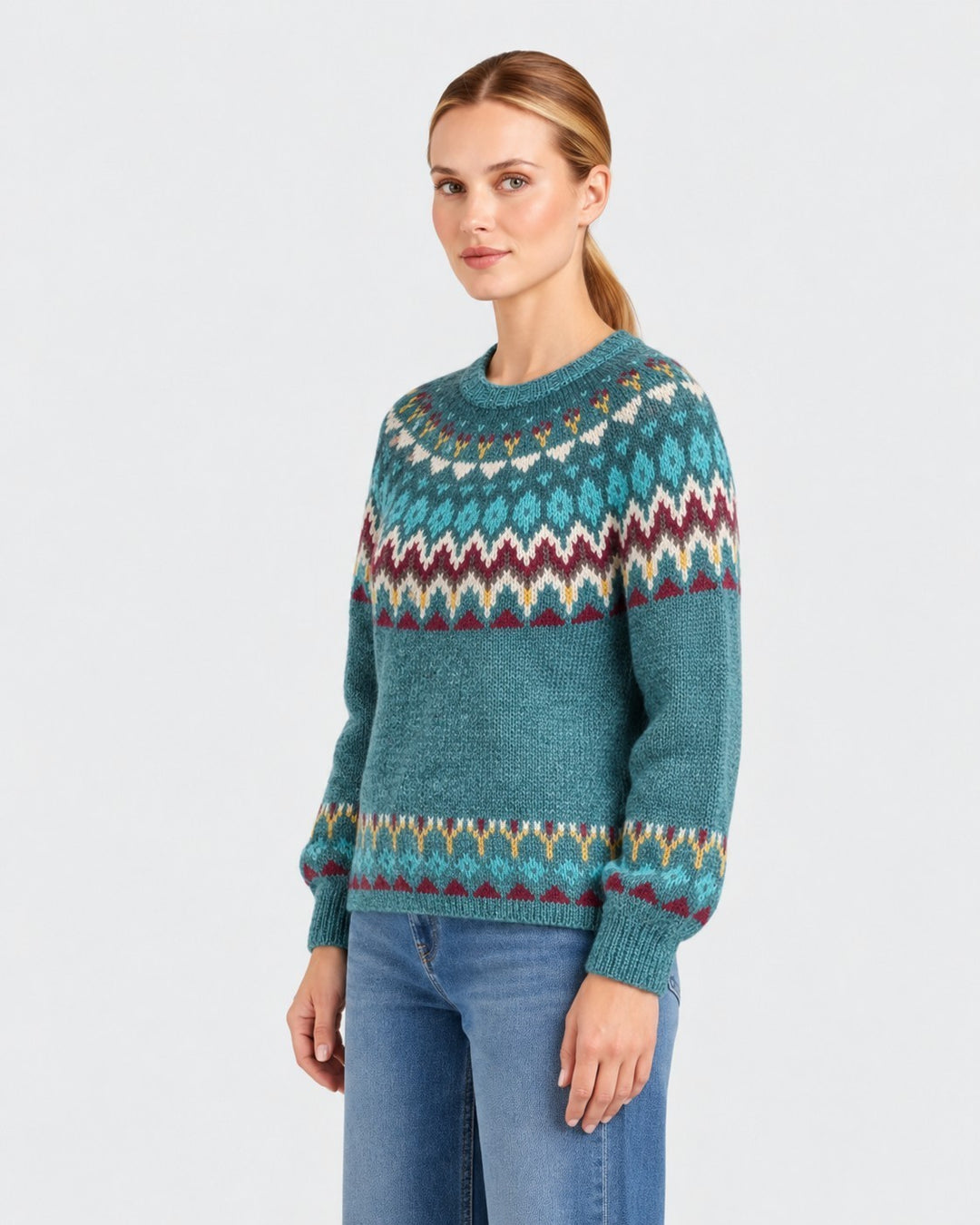 Luna Moda Barbara handmade teal wool sweater with a traditional Nordic fair isle pattern worn by a woman