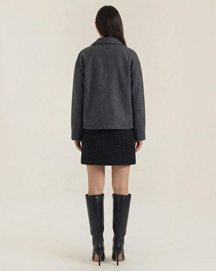 Luna Moda Teresa charcoal grey zip-up jacket with a relaxed fit worn by a model with a black skirt and tall boots