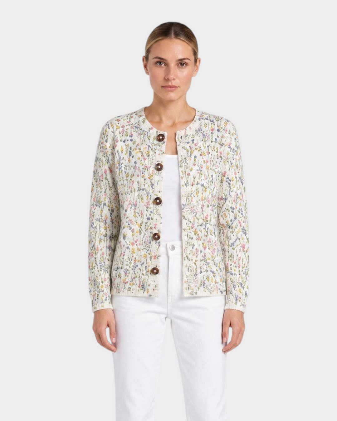 Luna Moda Veronica floral cardigan with wood-tone buttons over a white top and white jeans on a model