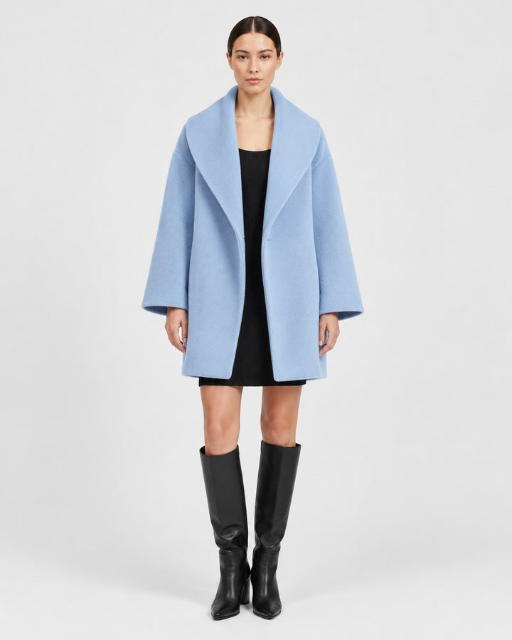 Luna Moda Veronika light blue wool-blend coat with a wide collar worn by a model with black dress and tall boots