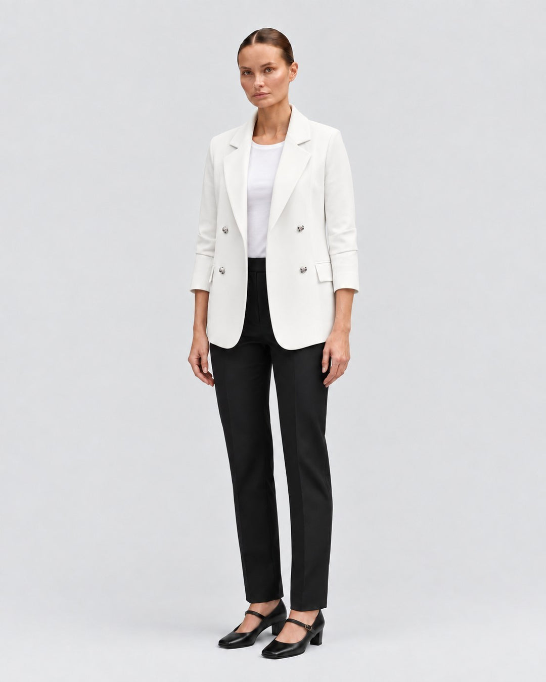 Luna Moda white double-breasted blazer worn by a model with black trousers and heels against a neutral background